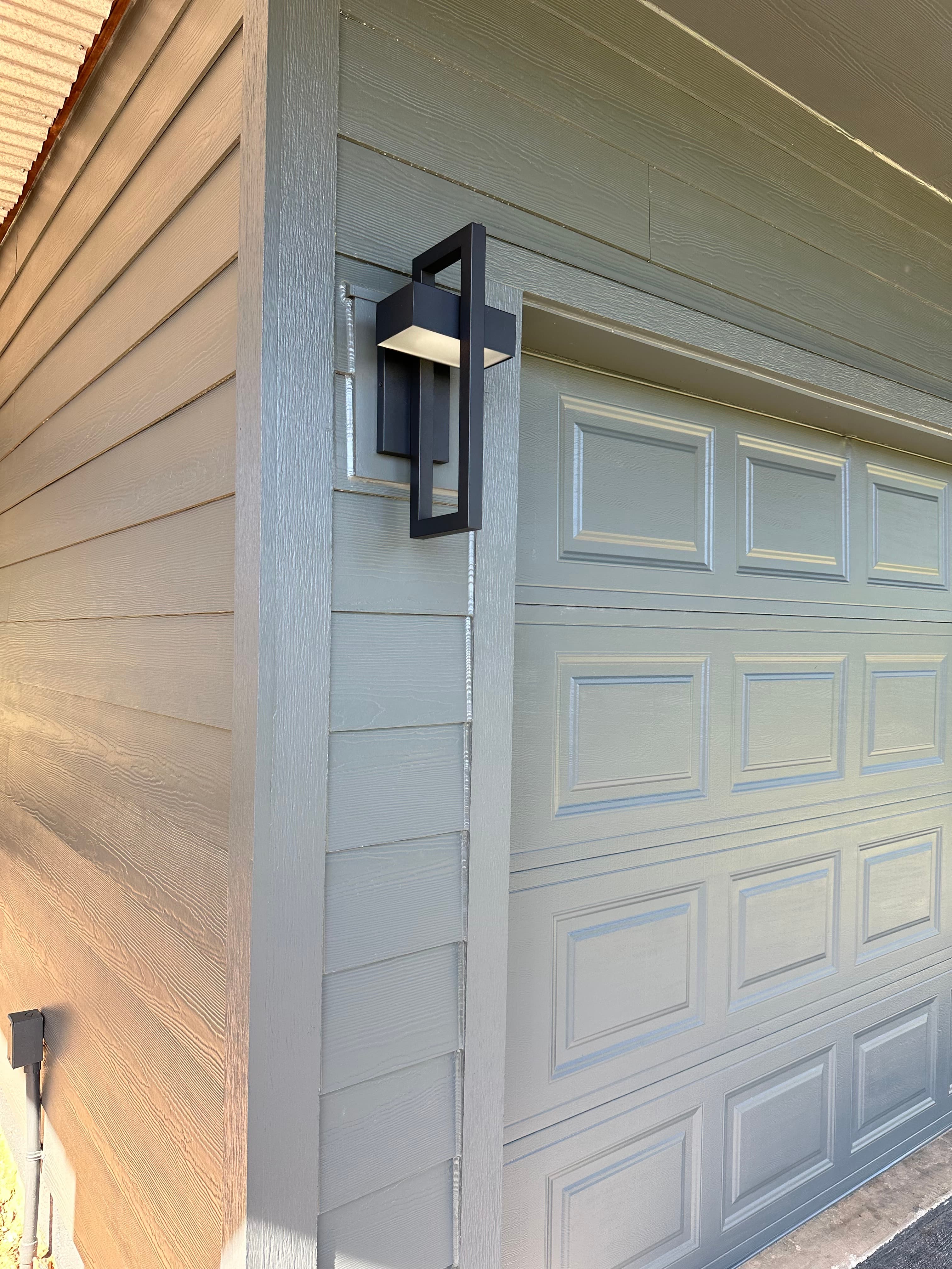 Exterior siding and garage door with modern hardware by NorCal Exteriors in Sacramento, CA